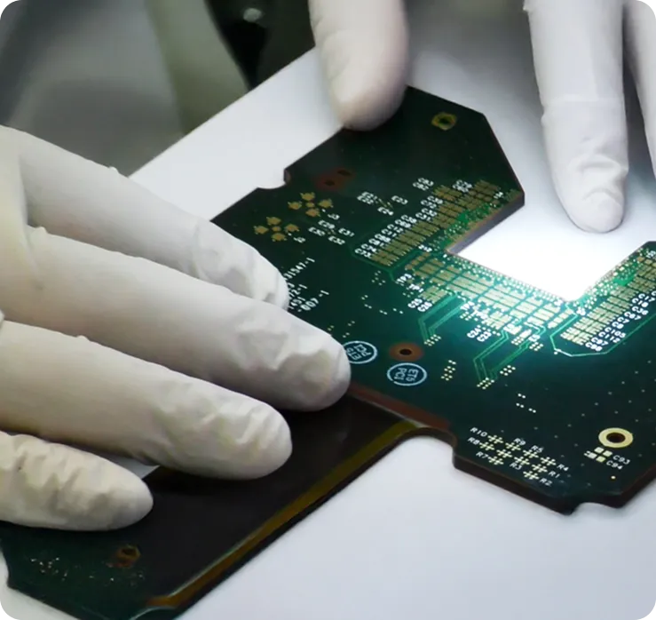 Technician inspecting a rigid-flex circuit for quality assurance in electronics manufacturing.